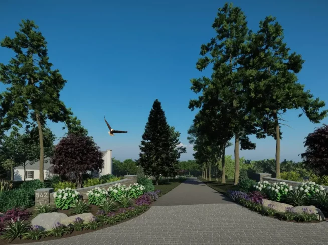ScapeWorx entrance landscape design featuring formal plantings, stone walls, and mature evergreens