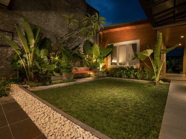 modern tropical courtyard lit with professional landscape lighting by ScapeWorx