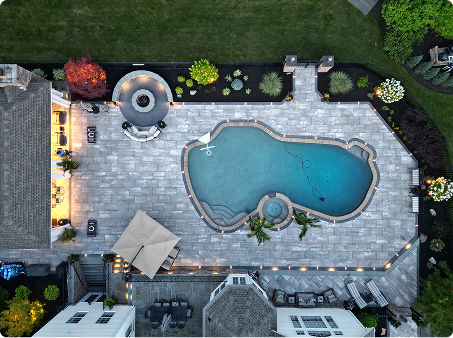ScapeWorx backyard patio installation with fire pit and fresh mulch around new plantings