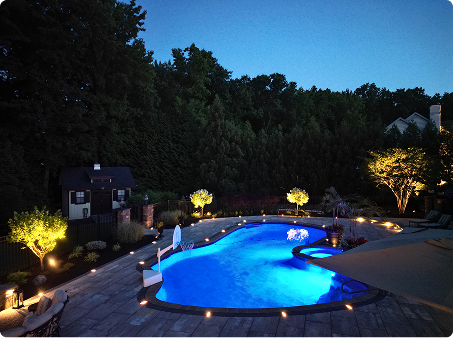 ScapeWorx custom patio and pool lighting installation at twilight