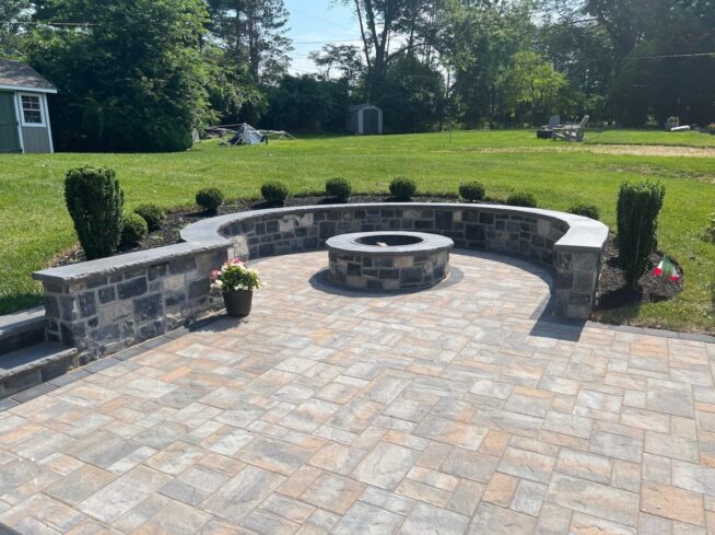 Circular fire pit surrounded by stone seating walls