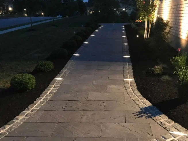 ScapeWorx custom walkway with integrated lighting and cobblestone border