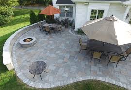 custom paver patio with fire pit and dining area by ScapeWorx