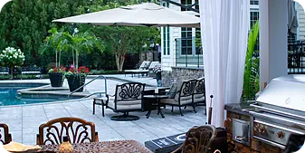 Shaded poolside lounge with patio seating by ScapeWorx