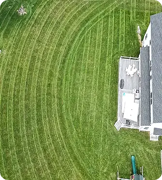 Aerial view of lawn mowing with circular mowing patterns.