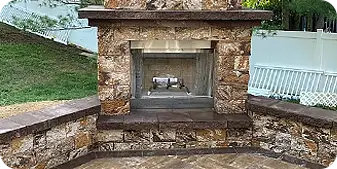 Custom stone fireplace with integrated seating in a Thornbury backyard by ScapeWorx