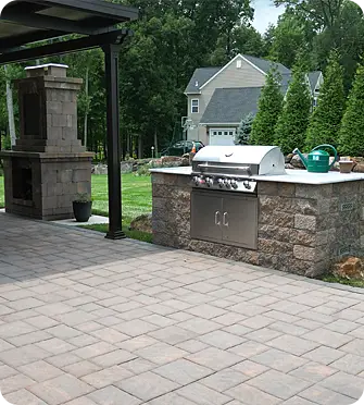Outdoor masonry project featuring a grill and stone fireplace by ScapeWorx.