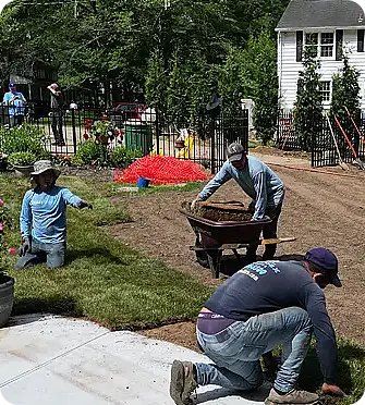 The ScapeWorx Sod Squad installing fresh sod in a garden.