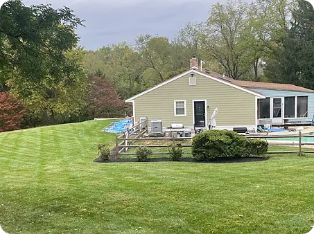 View of a well-maintained lawn after core aeration by ScapeWorx.