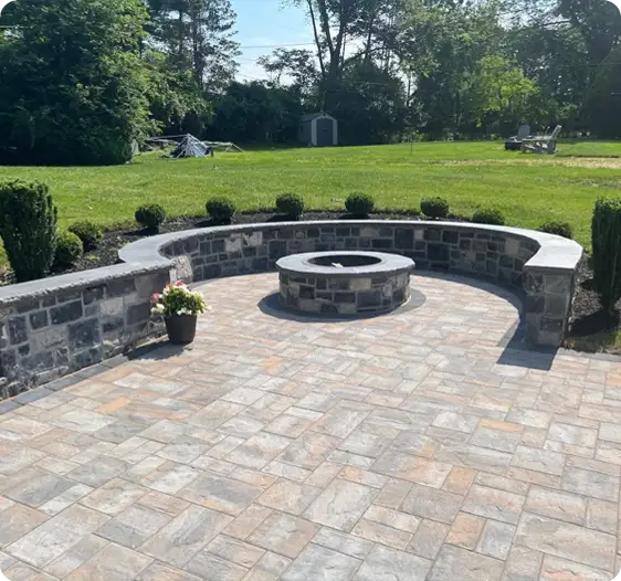 Circular fire pit surrounded by stone seating walls