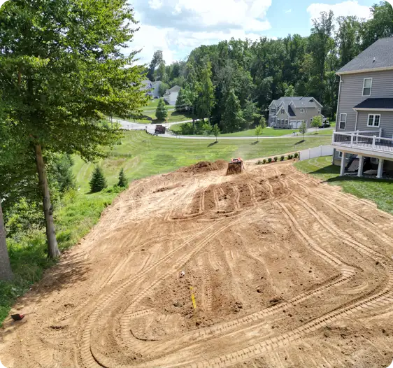 ScapeWorx grading and excavation project preparing a large residential backyard for lawn installation and proper drainage.