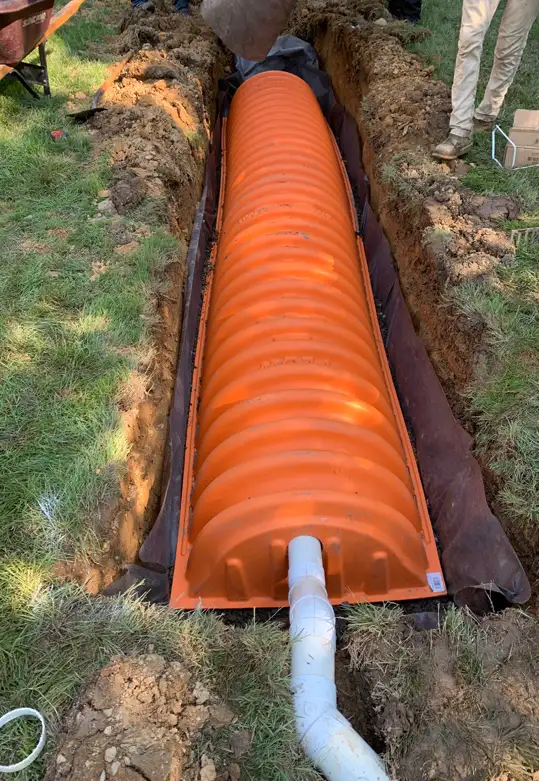 ScapeWorx installing an underground drainage chamber system to capture and manage excess stormwater in the landscape.