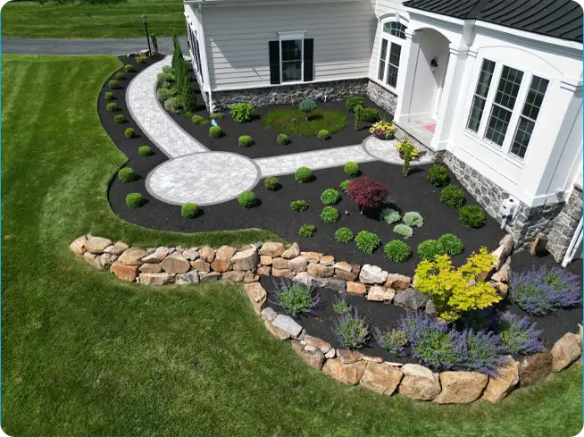 Aerial view of a beautiful landscape installation by ScapeWorx showcasing stone edging, plants that pop, and a perfectly placed paver walkway.