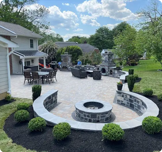 Custom-designed patio with stone fire pit, outdoor kitchen, all installed by ScapeWorx.