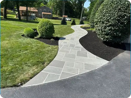 Curved stone pathway with immaculate edges and freshly mulched garden beds. Another installation by ScapeWorx.