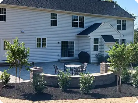 Another ScapeWorx backyard patio with seating area and stone retaining wall
