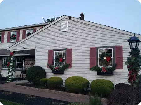 Neatly trimmed front yard shrubs adding clean lines to holiday decor