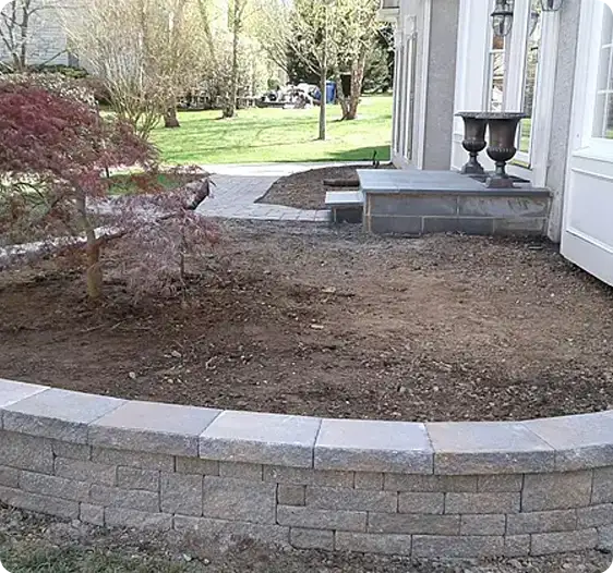 Retaining wall around garden bed with surrounding landscaping by ScapeWorx