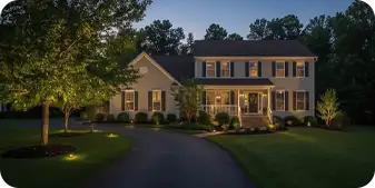 Professional landscape lighting on a suburban home in Greenville, Delaware.