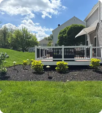 ScapeWorx installed fresh mulch and landscape lighting around a West Chester home's deck.