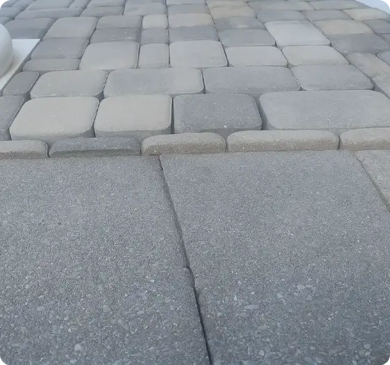 Close-up of newly installed or repaired grey paver walkway leading to larger pavers by ScapeWorx.
