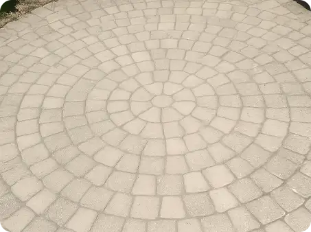 Circular paver patio with radial pattern, clean and well-maintained by ScapeWorx