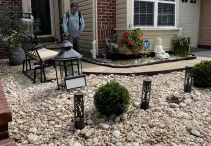 ScapeWorx river-rock drainage channel beside a landscaped home