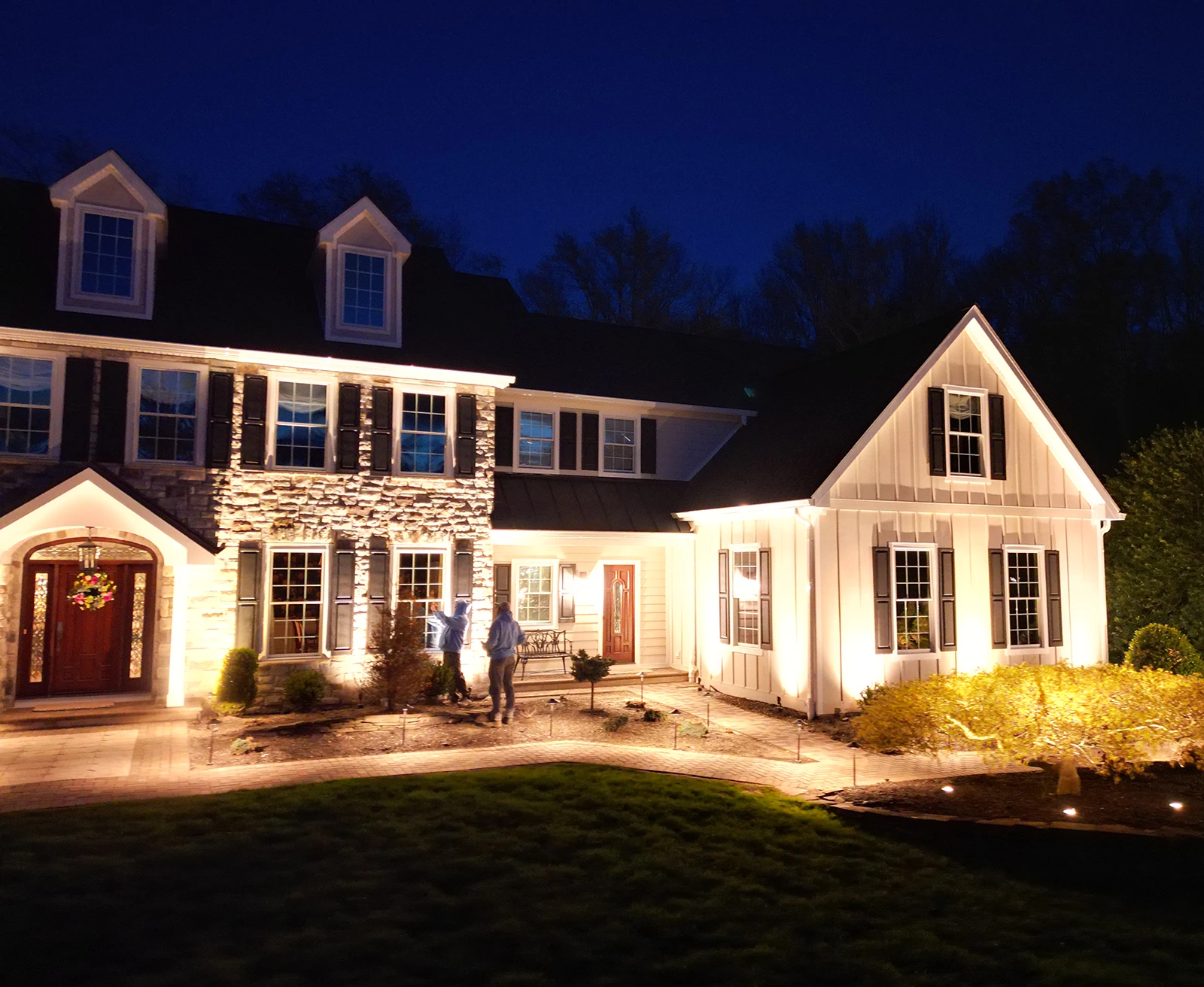 ScapeWorx front-entry landscape lighting illuminating a large home
