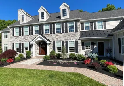 Luxury home with manicured landscaping by ScapeWorx